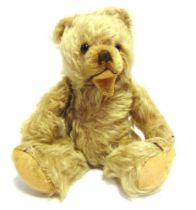 A HERMANN ZOTTY BLONDE MOHAIR TEDDY BEAR with dark orange glass eyes, a brown vertically stitched