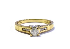 9CT GOLD DIAMOND SOLITAIRE RING central four claw set round brilliant cut diamond, flanked by