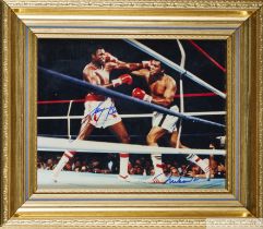 A colour autographed photograph of Muhammad Ali and Larry Holmes