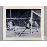 A large black and white photographic print of Sir Trevor Brooking scoring the winning goal in the 1