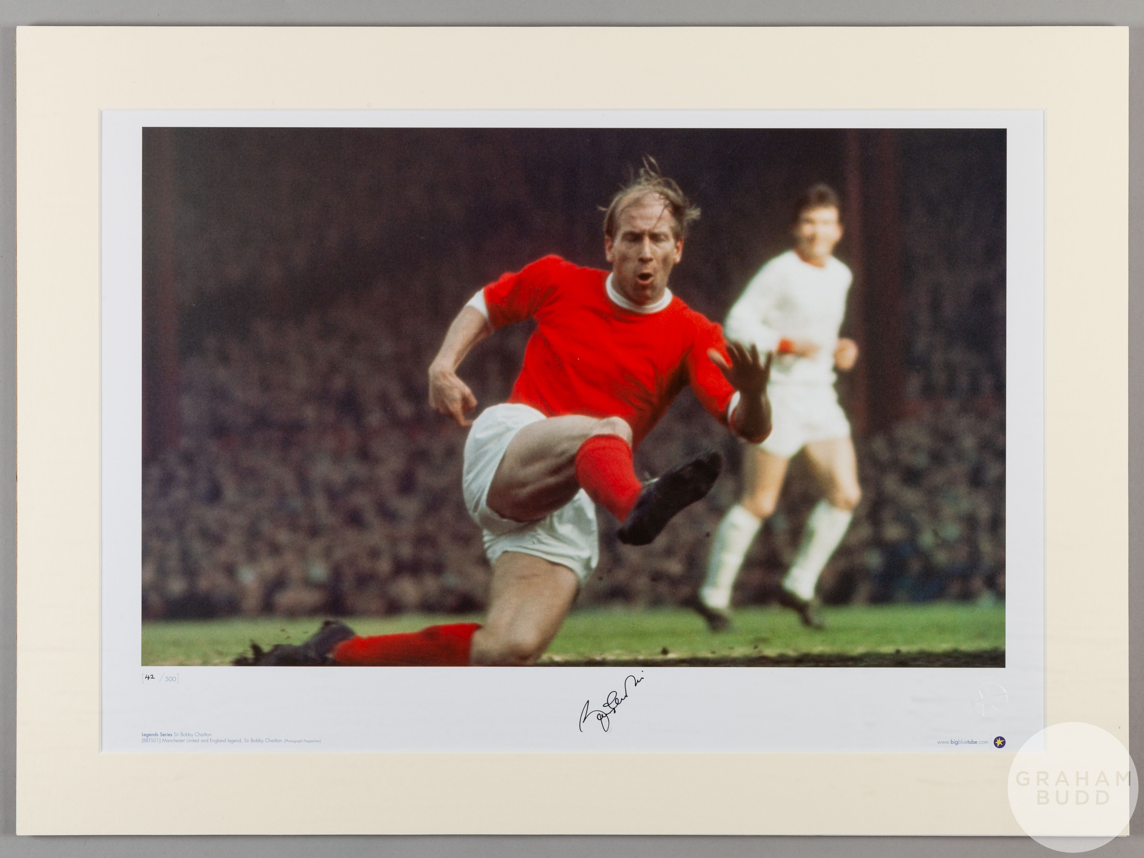 A large colour photographic print of Sir Bobby Charlton playing for Manchester United.