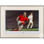 A large colour photographic print of Sir Bobby Charlton playing for Manchester United.