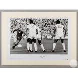 A large black and white photographic print of Sir Bobby Charlton playing against Benfica in the 1968