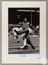 A large black and white photographic print of Eusebio playing for Benfica against AC Milan in the 1