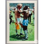 A large colour photographic print of Pele exchanging shirts with Bobby Moore following Brazil's def
