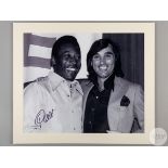 A large black and white photographic print of Pele and George Best