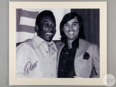 A large black and white photographic print of Pele and George Best
