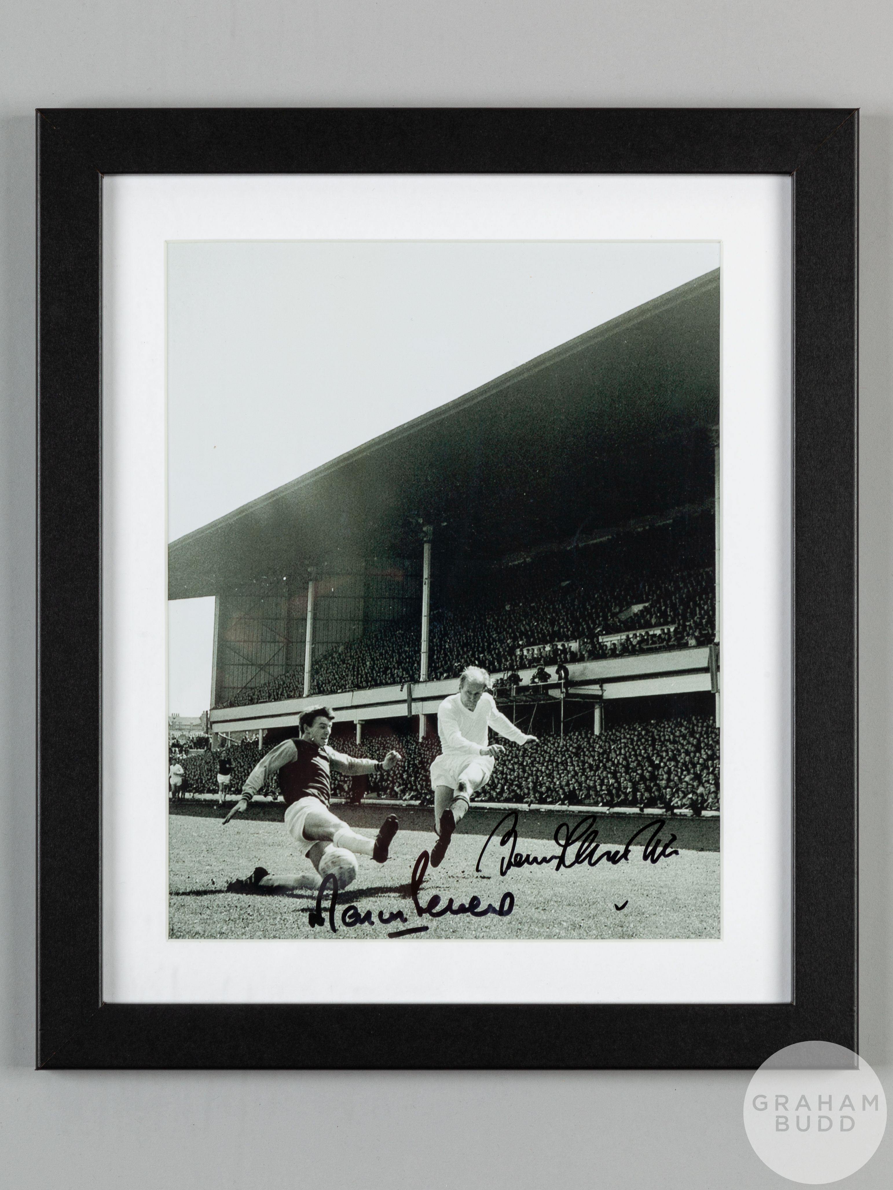 Double-signed framed b&w photograph of the 1966 World Cup winners Bobby Charlton and Martin Peters