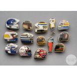 Twelve various enamel F1 lapel badges formed as racing helmets