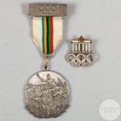 A 1936 Olympic enamel lapel badge inscribed 1936, XI. Olympiade Berlin