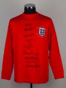 A red replica England 40th Anniversary shirt autographed by nine of the 1966 world Cup winning side
