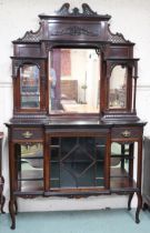 A late Victorian mahogany parlour cabinet with carved pierced surmount over triple plate mirror back