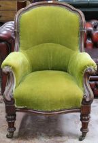 A Victorian walnut framed parlour armchair with green velour upholstery on turned supports, 97cm