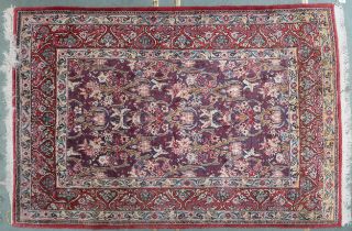 An extensively decorated patterned ground Indian Kerman rug with multicoloured borders depicting
