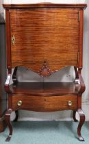 A 20th century mahogany serpentine front side cabinet with single door over open shelf over single