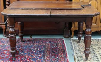 A Victorian oak wind out dining table on turned supports, 73cm high x 135cm long (180cm long with