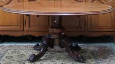 A Victorian walnut oval tilt top breakfast table on quadrupedal base, 70cm high x 153cm long x 128cm