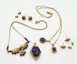 A collection of gold and yellow metal jewellery to include, amethyst and garnet pendants with