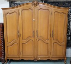 A 20th century continental style four door wardrobe with shaped panel doors on cabriole feet,