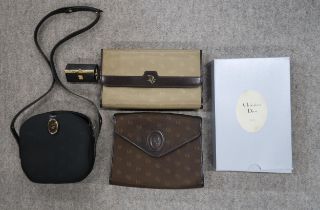 A Christian Dior cloth clutch bag with chain strap, and original box, two other Dior bags and a