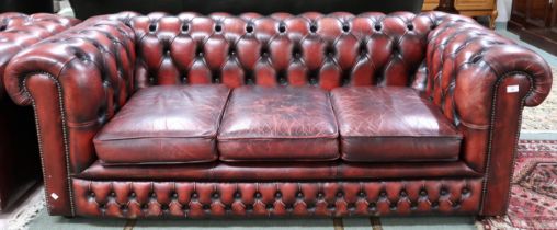 A 20th century oxblood leather upholstered Chesterfield style three seater club settee, 68cm high