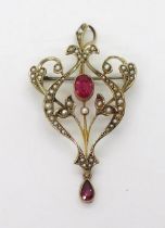 A 9ct gold Edwardian pendant brooch, set with pearls and red gems, with a detachable bail. Length