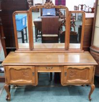 A 20th century oak continental style triple plate dressing table with single drawer flanked by