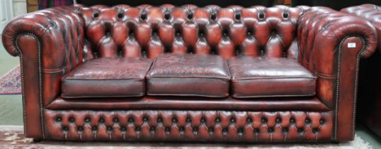 A 20th century oxblood leather upholstered Chesterfield style three seater club settee, 68cm high