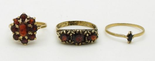 A 9ct gold garnet cluster ring size J1/2, a 9ct sapphire ring size K1/2, weight together 3gms and