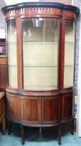 An Edwardian mahogany bow fronted display cabinet with moulded cornice over single bow glazed door