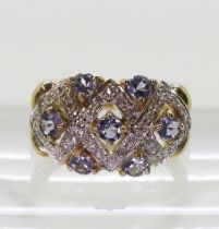 A 9ct gold ring by QVC set with tanzanites and diamond accents, finger size N1/2, weight 4.2gms
