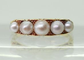 A five pearl ring in classic 18ct gold scroll mount, finger size O1/2, weight 3.9gms Condition