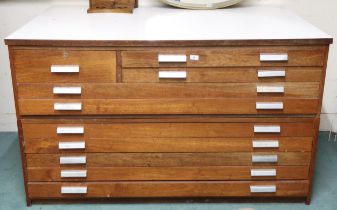 A 20th century beech plan chest with Formica top over single drawer alongside two narrow drawers