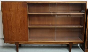A mid 20th century teak McIntosh of Kirkcaldy bookcase with single cabinet door alongside pair of