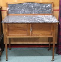 A late Victorian mahogany washstand with marble top and backsplash over pair of cabinet doors on