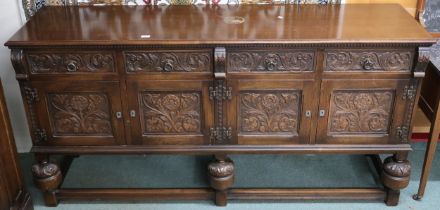 A 20th century stained oak Jaycee furniture sideboard with four drawers over two pairs of cabinet