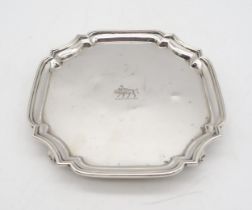 A George V silver waiter, by Adie Brothers, Birmingham 1936, of shaped form, engraved with an