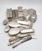 A collection of silver dressing sets, including a four piece set by Adie Brothers Ltd, Birmingham