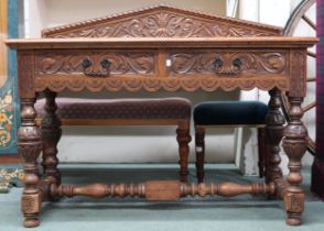 A late Victorian oak two drawer hall table on turned baluster supports joined by turned