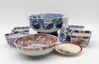 A Japanese blue and white bowl, a large imari bowl, four food bowls, a blue and white vase, and a