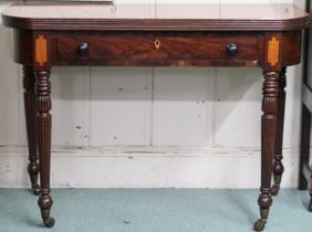 A Victorian mahogany fold-over tea table with single long drawer on turned reeded supports