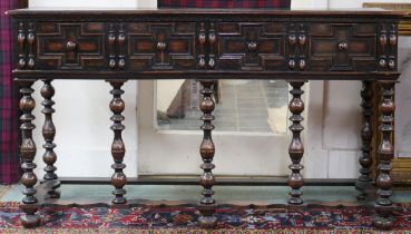 A 20th century oak buffet table with pair of drawers on turned supports joined by shaped stretchers,