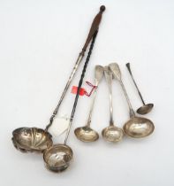 A collection of silver and white metal flatware, including a Georgian white metal ladle, inset