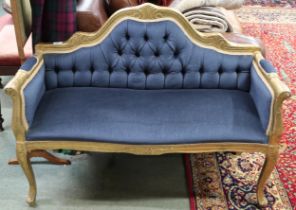 A Louis XVI style gilt framed window seat with blue velour button back upholstery on cabriole