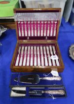 An oak canteen of EPNS mother of pearl handled fish knives and forks, by Martin Hall & Co, with