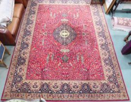 A red ground Grosvenor Wilton rug with dark blue diamond shaped central medallion on floral/