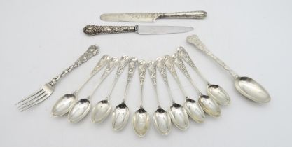 A set of ten Victorian silver tea spoons, by George Adam, London 1881, decorated in the aesthetic