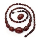 A long string of cherry amber coloured beads, and one loose bead, length 77cm, weight all together