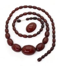 A long string of cherry amber coloured beads, and one loose bead, length 77cm, weight all together
