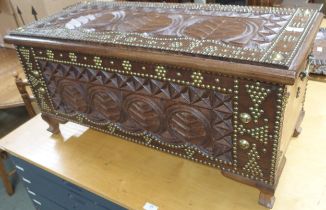 A 20th century carved Indonesian hardwood chest with extensive brass studs and rondels, 43cm high